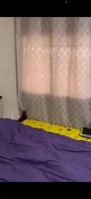 a bed with a yellow measuring tape next to a window at Appartement journalier in Rabat