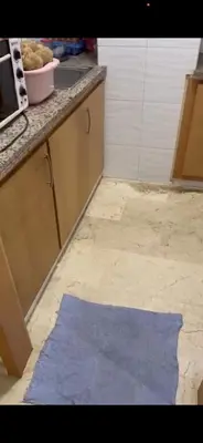 a kitchen with a blue rug on the floor at Appartement journalier in Rabat