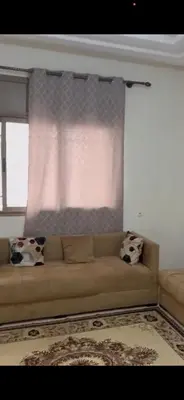 a couch in a living room with a window at Appartement journalier in Rabat