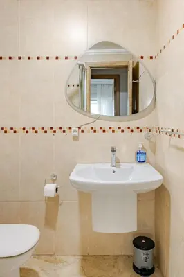 a bathroom with a sink and a mirror at Spacious, 2 BDR, Balcony, AC, Parking, Fiber Optic - Agdal in Rabat