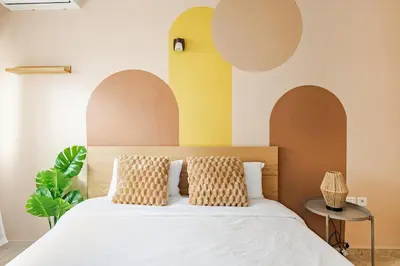 a bedroom with a bed with arches on the wall at Spacious, 2 BDR, Balcony, AC, Parking, Fiber Optic - Agdal in Rabat