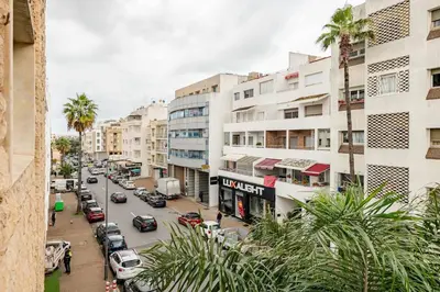 a view of a city street with cars and buildings at Spacious, 2 BDR, Balcony, AC, Parking, Fiber Optic - Agdal in Rabat