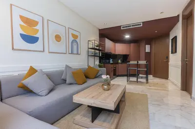 a living room with a couch and a coffee table at B-living Luxury studio Maarif palmier in Casablanca