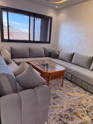 a living room with a couch and a coffee table at Comfortable 2-bedroom apartment, beach within walking distance in Bouznika