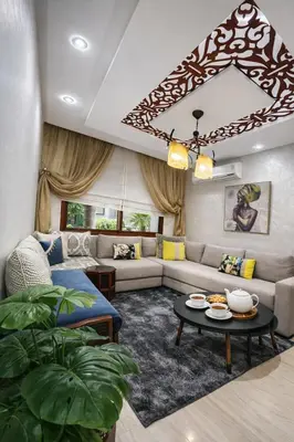 a living room with a couch and a table at Spacious 3 Bedroom Apartment in Rabat Near Moulay El Hassan Stadium Malls and Embassies in Rabat