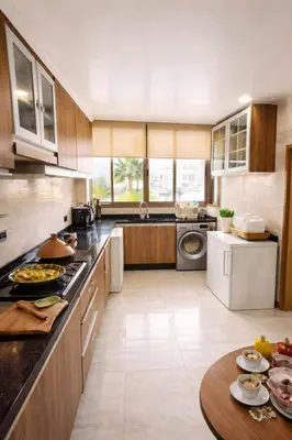 a large kitchen with a table with food on it at Spacious 3 Bedroom Apartment in Rabat Near Moulay El Hassan Stadium Malls and Embassies in Rabat