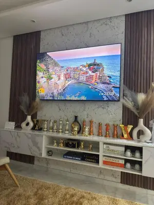 a living room with a flat screen tv on a wall at Granada in Rabat