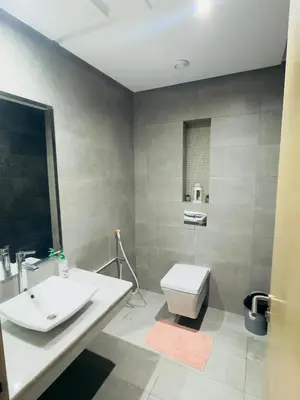 a bathroom with a white sink and a toilet at Granada in Rabat