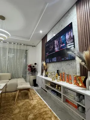 a living room with a couch and a tv at Granada in Rabat