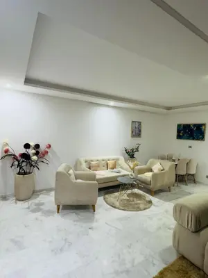 a living room with couches and chairs and a table at Granada in Rabat
