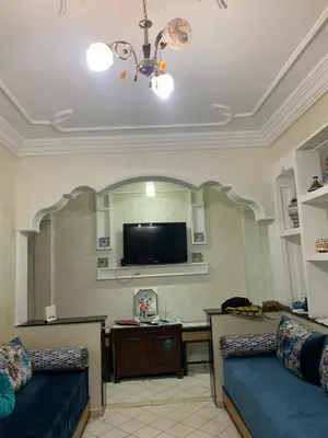 a living room with two couches and a flat screen tv at Halimadriss in Rabat