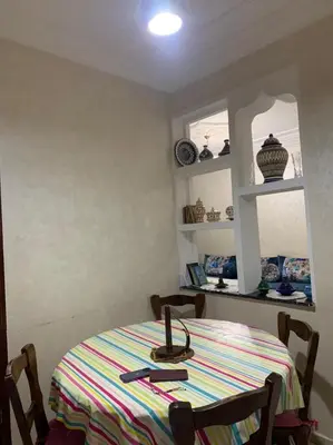 a dining room table with a striped table cloth on it at Halimadriss in Rabat