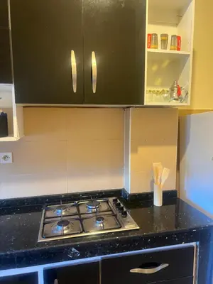 a kitchen with a stove and a black counter top at Appartement in Mohammedia