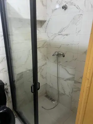 a shower with a glass door in a bathroom at Appartement in Mohammedia