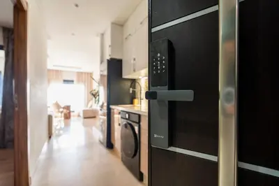 a kitchen with a door open to a living room at Casablanca Panorama Apartment in Casablanca