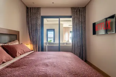 a bedroom with a large bed and a couch at Casablanca Panorama Apartment in Casablanca