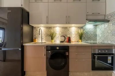 a kitchen with a washer and a dishwasher at Casablanca Panorama Apartment in Casablanca