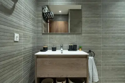 a bathroom with a sink and a mirror at Casablanca Panorama Apartment in Casablanca