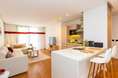 a kitchen and living room with a white counter top at Central Studio CFC I Gym I Pool in Casablanca