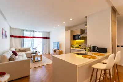 a kitchen and living room with a couch and a table at Central Studio CFC I Gym I Pool in Casablanca