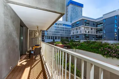 a balcony with a chair and some buildings at Central Studio CFC I Gym I Pool in Casablanca