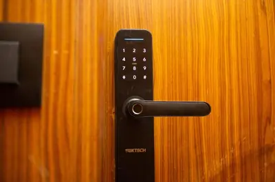a black remote control on a wooden door at Cosy Flat for Business Trip at CFC - Infinity Pool in Casablanca