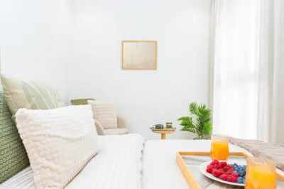 a living room with a white couch with a tray of fruit at M Studio cosy princesses in Casablanca