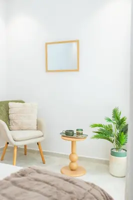 a living room with a chair and a table at M Studio cosy princesses in Casablanca