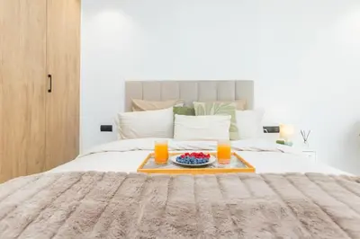a bed with a tray with two glasses of orange juice at M Studio cosy princesses in Casablanca