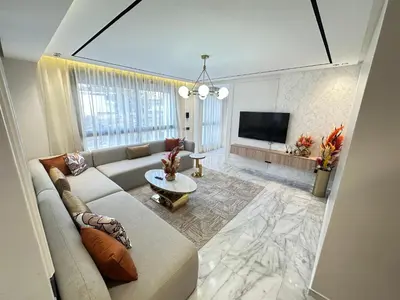 a living room with a couch and a tv at France Ville 2 Appartement Meublé Premium avec Terrasse in Maarif