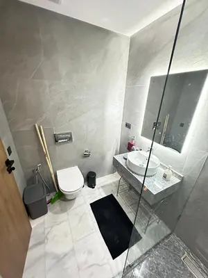 a bathroom with a toilet and a sink and a mirror at France Ville 2 Appartement Meublé Premium avec Terrasse in Maarif