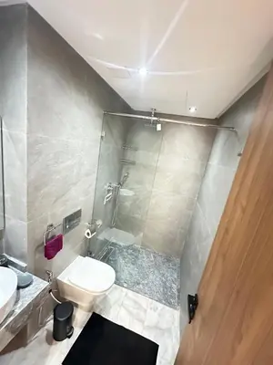 a bathroom with a shower and a toilet and a sink at France Ville 2 Appartement Meublé Premium avec Terrasse in Maarif