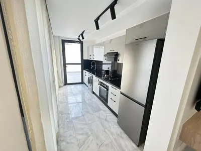 a kitchen with a refrigerator and a stove at France Ville 2 Appartement Meublé Premium avec Terrasse in Maarif
