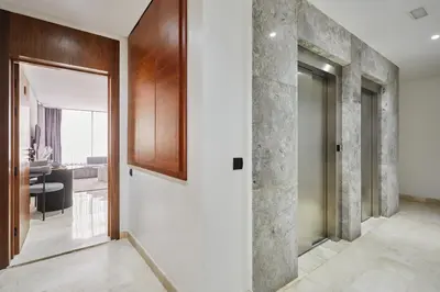 a hallway with a door leading to a living room at Luxueux Appartement Sécurisé in Casablanca