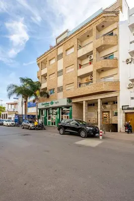 a black car parked in front of a building at Luxurious 2 BR, AC, Parking, Elevator - Mall Arribat Center, Agdal in Rabat