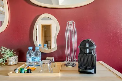 a coffee maker sitting on a table with a mirror at Luxurious 2 BR, AC, Parking, Elevator - Mall Arribat Center, Agdal in Rabat