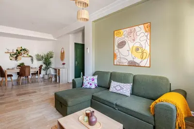 a living room with a couch and a table at Modern, 1 BDR, AC, Parking, Elevator, Fiber Optic - Agdal in Rabat