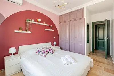 a bedroom with a white bed with a red wall at Modern, 1 BDR, AC, Parking, Elevator, Fiber Optic - Agdal in Rabat