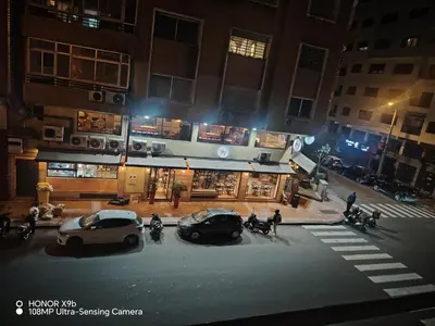two cars parked in front of a store at night at Appartement 2mars in Casablanca