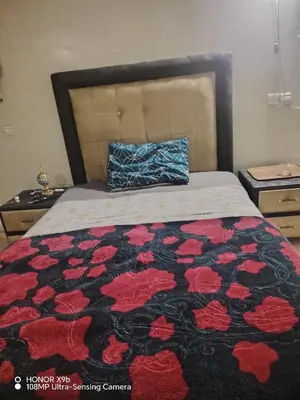 a bedroom with a bed with a black and red blanket at Appartement 2mars in Casablanca