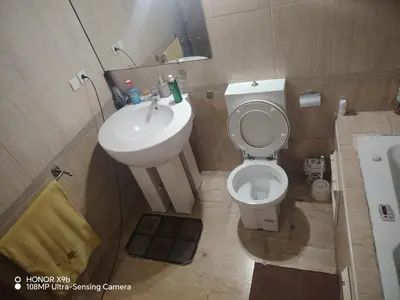 a small bathroom with a toilet and a sink at Appartement 2 mars in Casablanca
