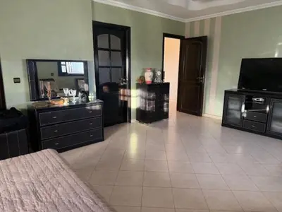 a large living room with a television and a couch at VILLA BOUSKOURA Casablanca in Casablanca