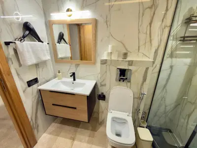 a bathroom with a toilet and a sink and a shower at Appartement de Luxe près du CFC et de l Hôpital Cheikh Khalifa in Casablanca