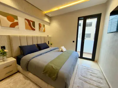 a bedroom with a large bed and a window at Appartement de Luxe près du CFC et de l Hôpital Cheikh Khalifa in Casablanca