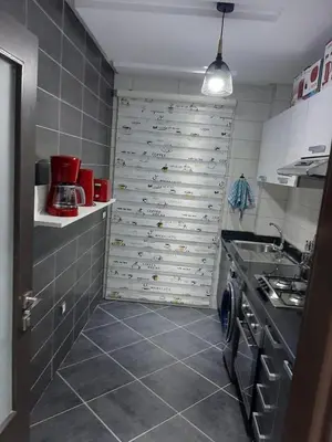 a kitchen with a wall of wine bottles at Appartement pied sur mer in Mohammedia