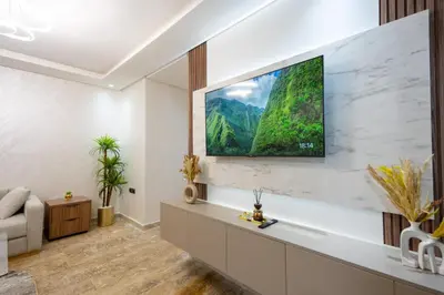 a living room with a tv on a wall at Magnificent apartment 2 in Casablanca