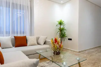 a living room with a couch and a glass table at Magnificent apartment 2 in Casablanca
