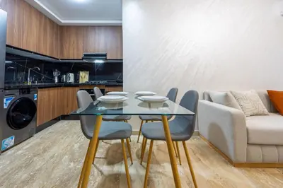 a dining room with a glass table and a couch at Magnificent apartment 2 in Casablanca