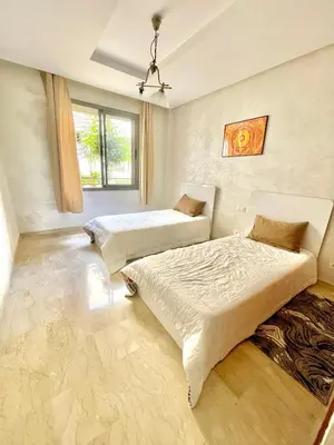 a bedroom with two beds and a window at Taj collection 1 in Casablanca