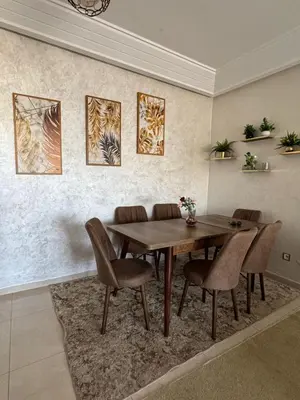 a dining room with a wooden table and chairs at Luxury apartments in Mansouria